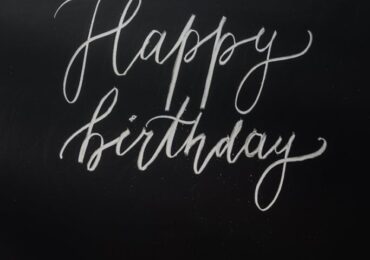 Stylish chalkboard with 'Happy Birthday' in handwritten script, perfect for celebrations.